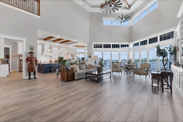 565 Green Dolphin Dr S, Placida, FL 33946 - living area with a ceiling fan, a high ceiling, and light wood-style flooring