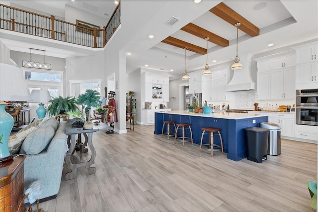 565 Green Dolphin Dr S, Placida, FL 33946 - living room with a towering ceiling, light wood-style floors, baseboards, recessed lighting, and beamed ceiling