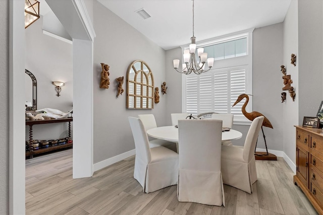 565 Green Dolphin Dr S, Placida, FL 33946 - dining room with a chandelier, light wood finished floors, baseboards, and high vaulted ceiling