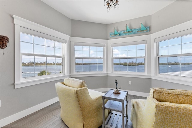 565 Green Dolphin Dr S, Placida, FL 33946 - sitting room featuring light wood-style flooring, baseboards, and a water view