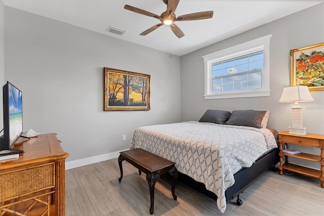 565 Green Dolphin Dr S, Placida, FL 33946 - bedroom with light wood finished floors, baseboards, and ceiling fan