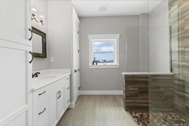 565 Green Dolphin Dr S, Placida, FL 33946 - bathroom with vanity, baseboards, walk in shower, and wood finished floors