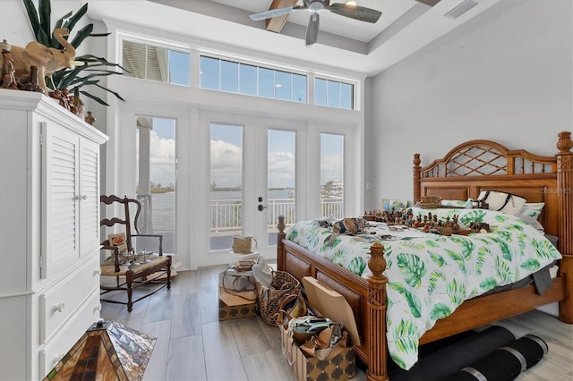 565 Green Dolphin Dr S, Placida, FL 33946 - bedroom featuring access to outside, french doors, light wood-type flooring, and ceiling fan