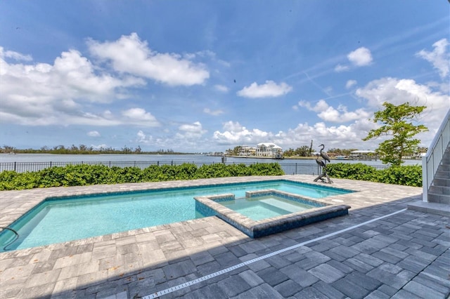 565 Green Dolphin Dr S, Placida, FL 33946 - view of swimming pool featuring a patio area, a pool with connected hot tub, and a water view