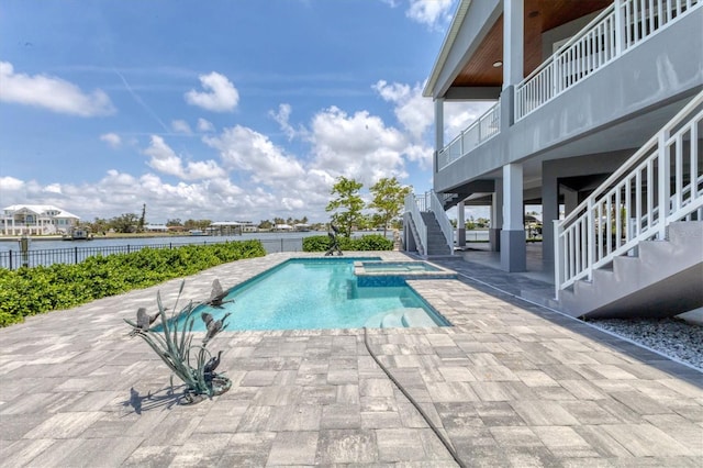 565 Green Dolphin Dr S, Placida, FL 33946 - view of swimming pool with stairs, a patio, a water view, and a pool with connected hot tub