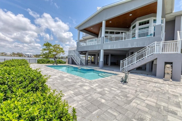 565 Green Dolphin Dr S, Placida, FL 33946 - view of swimming pool featuring stairs, a patio area, and a pool with connected hot tub