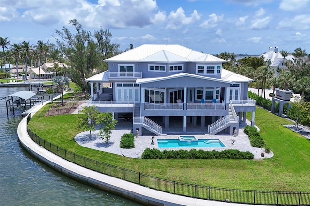 565 Green Dolphin Dr S, Placida, FL 33946 - rear view of property featuring stairway, a sunroom, a patio, a balcony, and a pool with connected hot tub