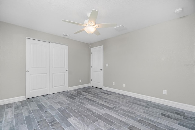 8270 Cook Ct, Port Charlotte, FL 33981 - unfurnished bedroom with baseboards, wood finished floors, a closet, and ceiling fan