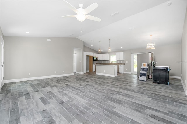 8270 Cook Ct, Port Charlotte, FL 33981 - unfurnished living room with vaulted ceiling, baseboards, ceiling fan, light wood-style flooring, and recessed lighting