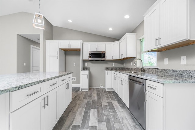 8270 Cook Ct, Port Charlotte, FL 33981 - kitchen with appliances with stainless steel finishes, a sink, vaulted ceiling, light stone countertops, and white cabinetry