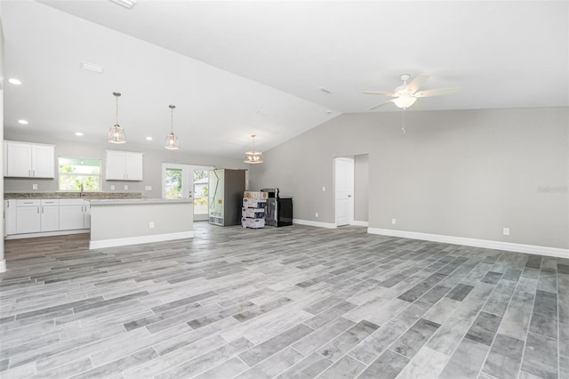 8270 Cook Ct, Port Charlotte, FL 33981 - unfurnished living room with ceiling fan, vaulted ceiling, baseboards, light wood-style floors, and recessed lighting