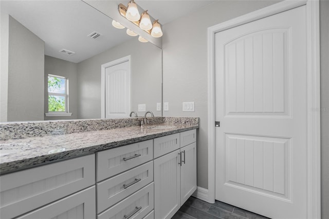 8270 Cook Ct, Port Charlotte, FL 33981 - bathroom featuring vanity, baseboards, and wood finished floors