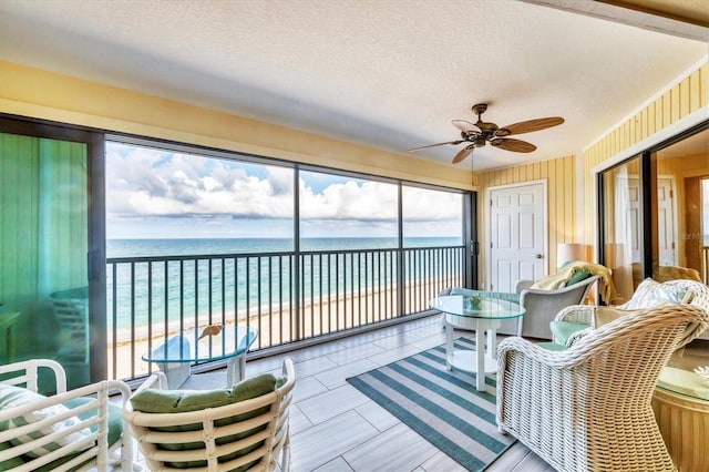 2700 N Beach Rd Unit B205, Englewood, FL 34223 - sunroom with a ceiling fan, view of water and beach, and a textured ceiling