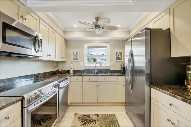 2700 N Beach Rd Unit B205, Englewood, FL 34223 - kitchen featuring stainless steel appliances, a sink, crown molding, a ceiling fan, and dark stone countertops