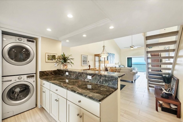 2700 N Beach Rd Unit B205, Englewood, FL 34223 - laundry room with stacked washer and clothes dryer, recessed lighting, a ceiling fan, light wood-type flooring, and ornamental molding