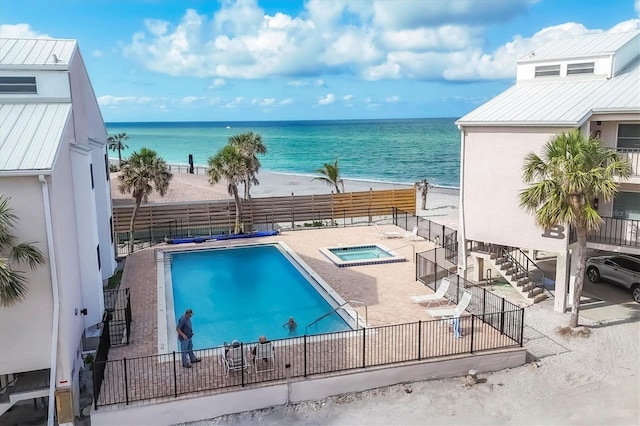 2700 N Beach Rd Unit B205, Englewood, FL 34223 - community pool with a hot tub, a water view, stairway, a fenced backyard, and a patio