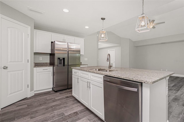 13529 Boatbill Ln, Port Charlotte, FL 33981 - kitchen featuring stainless steel appliances, vaulted ceiling, dark wood-style flooring, white cabinets, and a ceiling fan
