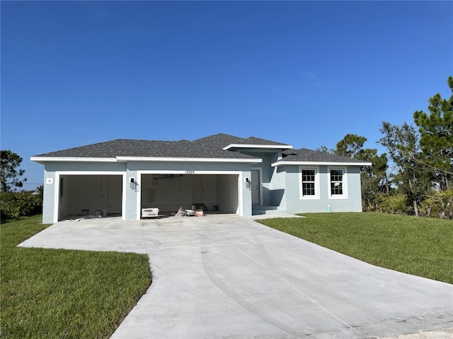 13529 Boatbill Ln, Port Charlotte, FL 33981 - view of front of home with a garage, driveway, a front lawn, and stucco siding