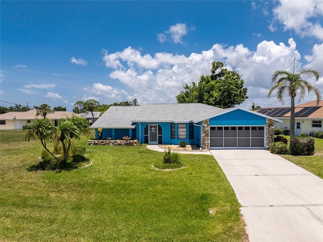 23 Bunker Cir, Rotonda West, FL 33947 - single story home with stone siding, an attached garage, a front lawn, and concrete driveway
