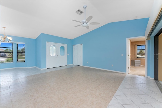 23 Bunker Cir, Rotonda West, FL 33947 - unfurnished living room featuring lofted ceiling, light tile patterned flooring, a ceiling fan, plenty of natural light, and a chandelier