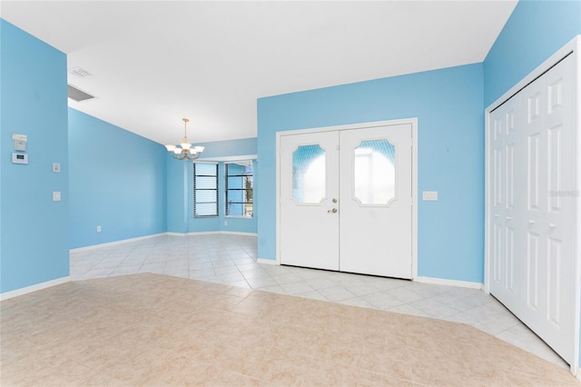 23 Bunker Cir, Rotonda West, FL 33947 - foyer with a chandelier, tile patterned floors, baseboards, and french doors