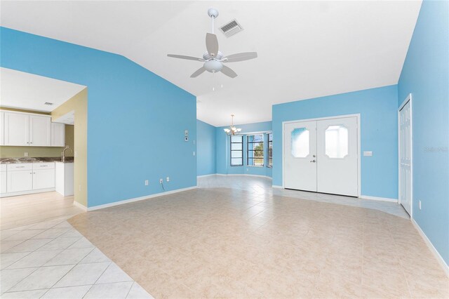 23 Bunker Cir, Rotonda West, FL 33947 - unfurnished living room featuring lofted ceiling, light tile patterned floors, a sink, a ceiling fan, and a chandelier