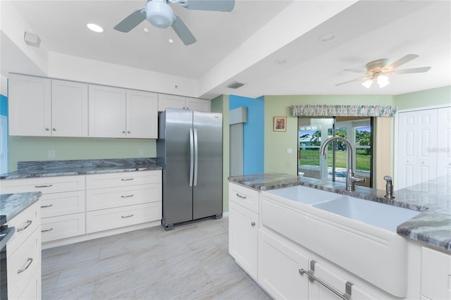 23 Bunker Cir, Rotonda West, FL 33947 - kitchen with freestanding refrigerator, a ceiling fan, a sink, and dark stone counters