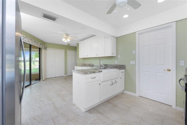 23 Bunker Cir, Rotonda West, FL 33947 - kitchen featuring freestanding refrigerator, a ceiling fan, a sink, white cabinetry, and recessed lighting