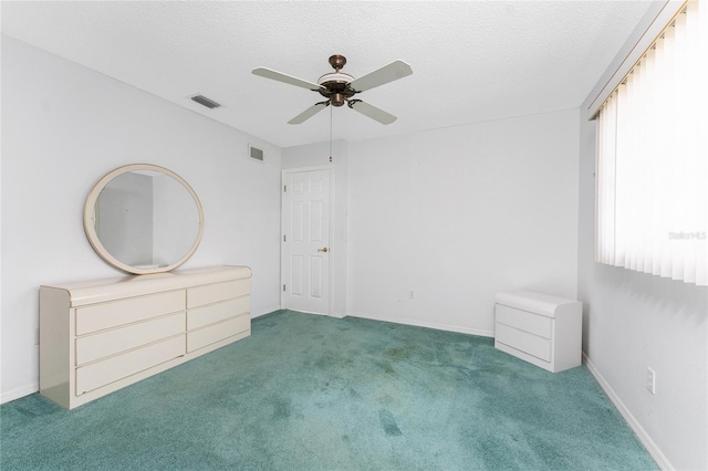 23 Bunker Cir, Rotonda West, FL 33947 - unfurnished bedroom featuring carpet flooring, ceiling fan, and a textured ceiling