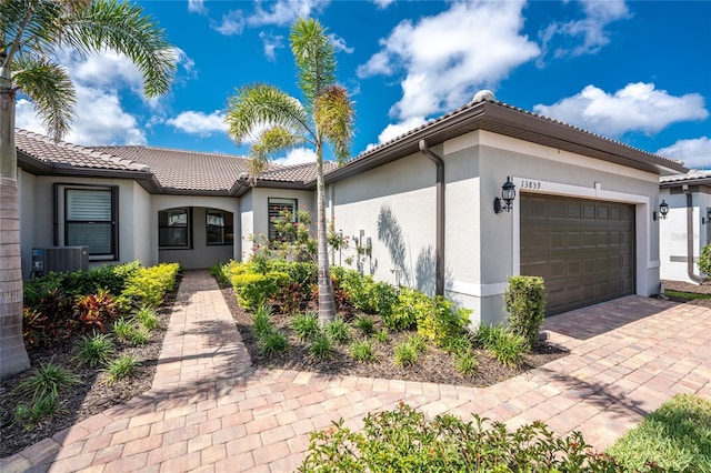 13859 Vadini St, Venice, FL 34293 - view of front of home with stucco siding, a garage, and a tiled roof