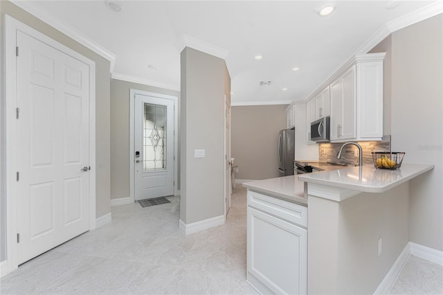 13859 Vadini St, Venice, FL 34293 - kitchen with appliances with stainless steel finishes, white cabinetry, backsplash, crown molding, and light countertops