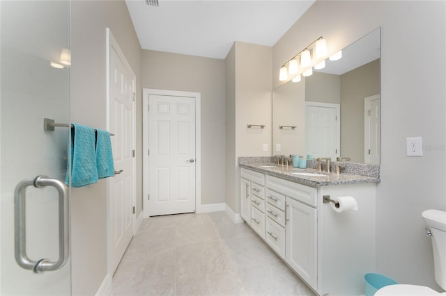 13859 Vadini St, Venice, FL 34293 - full bathroom with double vanity, toilet, tile patterned flooring, and baseboards