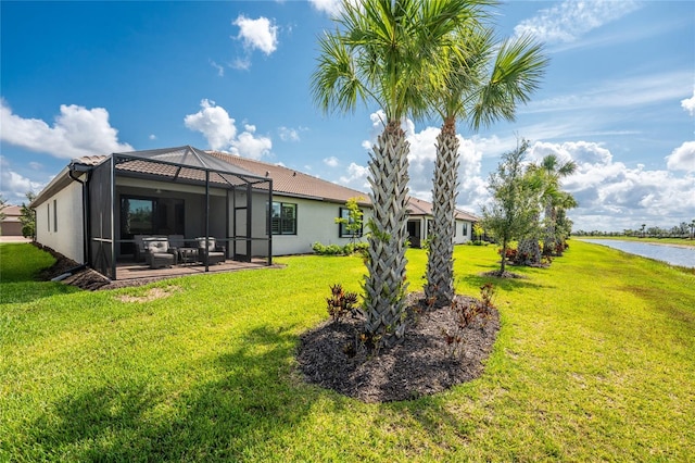 13859 Vadini St, Venice, FL 34293 - rear view of house featuring a lawn, stucco siding, a lanai, a patio area, and a water view