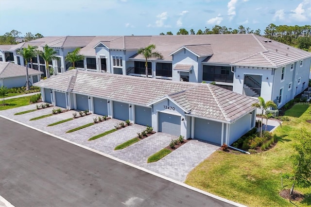12470 Wellen Golf St Unit 108, Venice, FL 34293 - view of front facade with a tiled roof, stucco siding, and community garages