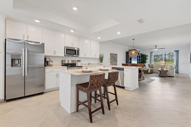 12470 Wellen Golf St Unit 108, Venice, FL 34293 - kitchen featuring stainless steel appliances, a peninsula, open floor plan, white cabinets, and a sink