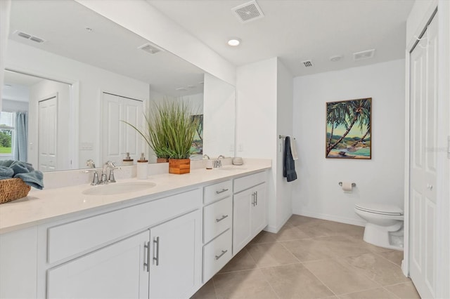 12470 Wellen Golf St Unit 108, Venice, FL 34293 - full bathroom with double vanity, toilet, tile patterned flooring, and baseboards