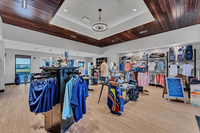 12470 Wellen Golf St Unit 108, Venice, FL 34293 - misc room featuring a raised ceiling, a chandelier, and light wood-type flooring
