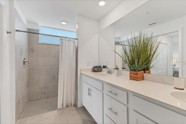 12470 Wellen Golf St Unit 108, Venice, FL 34293 - full bathroom featuring double vanity, a tile shower, recessed lighting, and tile patterned flooring