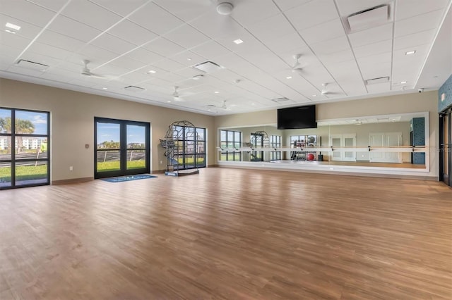 12470 Wellen Golf St Unit 108, Venice, FL 34293 - exercise area with a paneled ceiling, wood finished floors, and baseboards