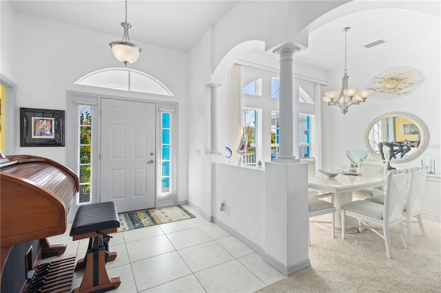 116 Tournament Rd, Rotonda West, FL 33947 - entryway with ornate columns, arched walkways, a towering ceiling, light tile patterned floors, and a chandelier