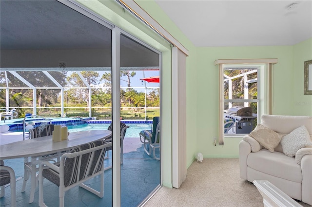 116 Tournament Rd, Rotonda West, FL 33947 - carpeted living area featuring a sunroom and baseboards