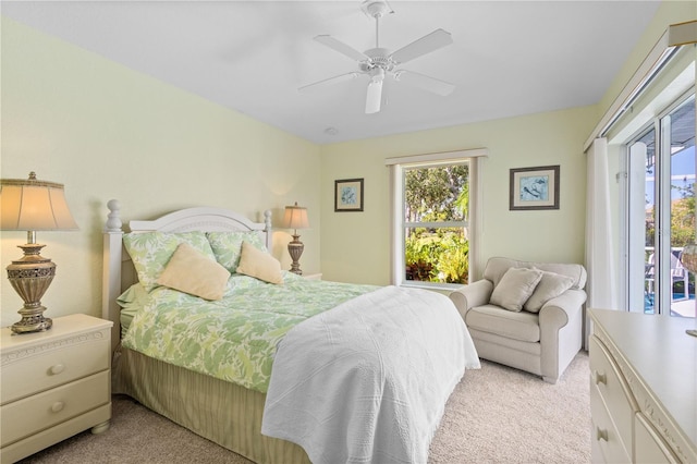 116 Tournament Rd, Rotonda West, FL 33947 - bedroom featuring light carpet, multiple windows, access to outside, and a ceiling fan