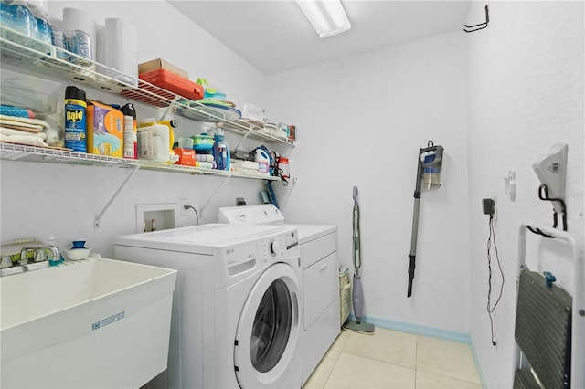 116 Tournament Rd, Rotonda West, FL 33947 - washroom featuring washing machine and dryer, light tile patterned floors, and baseboards