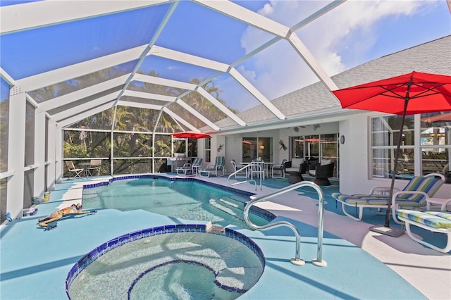 116 Tournament Rd, Rotonda West, FL 33947 - view of swimming pool featuring a pool with connected hot tub, a patio, and glass enclosure