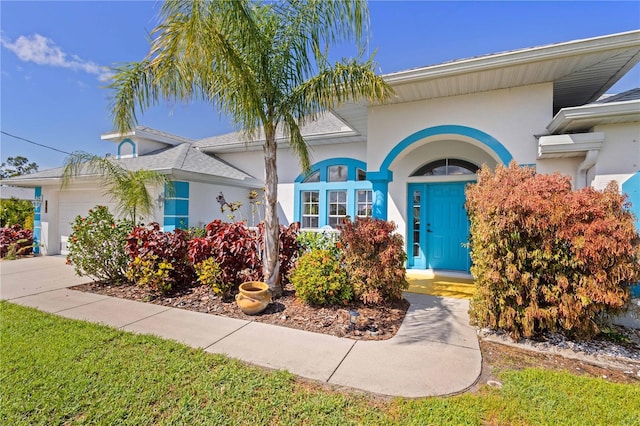 116 Tournament Rd, Rotonda West, FL 33947 - view of front of home with stucco siding and an attached garage