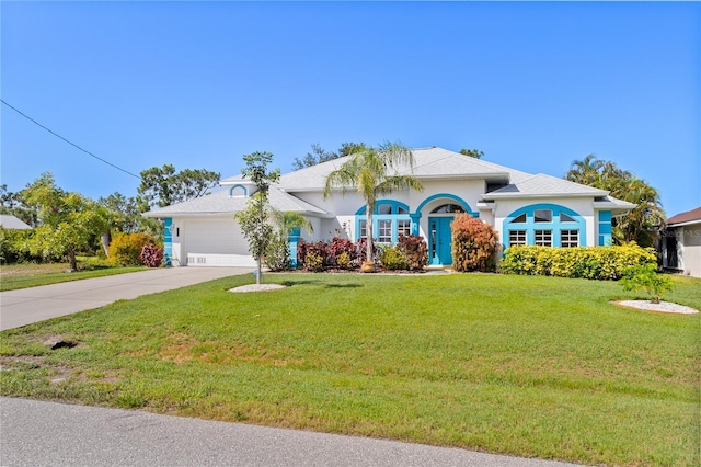 116 Tournament Rd, Rotonda West, FL 33947 - view of front of house featuring concrete driveway, a garage, a front yard, and stucco siding