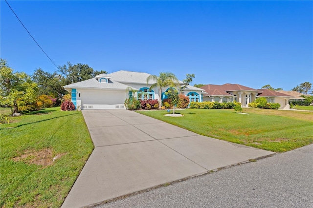 116 Tournament Rd, Rotonda West, FL 33947 - view of front of property featuring a garage, a front lawn, and driveway