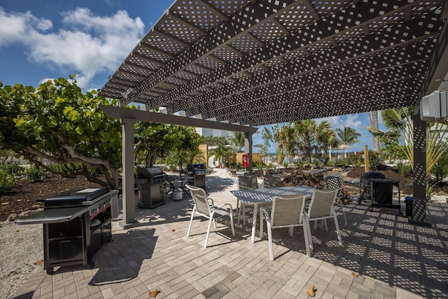 5700 Gulf Shores Dr Unit B-137, Boca Grande, FL 33921 - view of patio / terrace featuring area for grilling, a pergola, and outdoor dining space