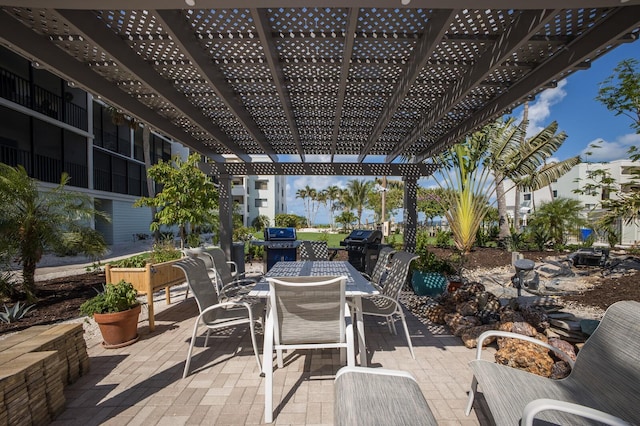 5700 Gulf Shores Dr Unit B-137, Boca Grande, FL 33921 - view of patio featuring a pergola, outdoor dining area, and a grill