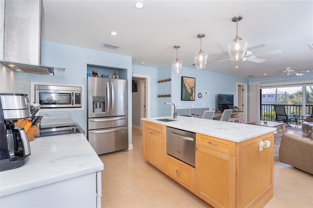 180 N Gulf Blvd Unit 5, Placida, FL 33946 - kitchen with appliances with stainless steel finishes, open floor plan, wall chimney range hood, a sink, and light brown cabinetry